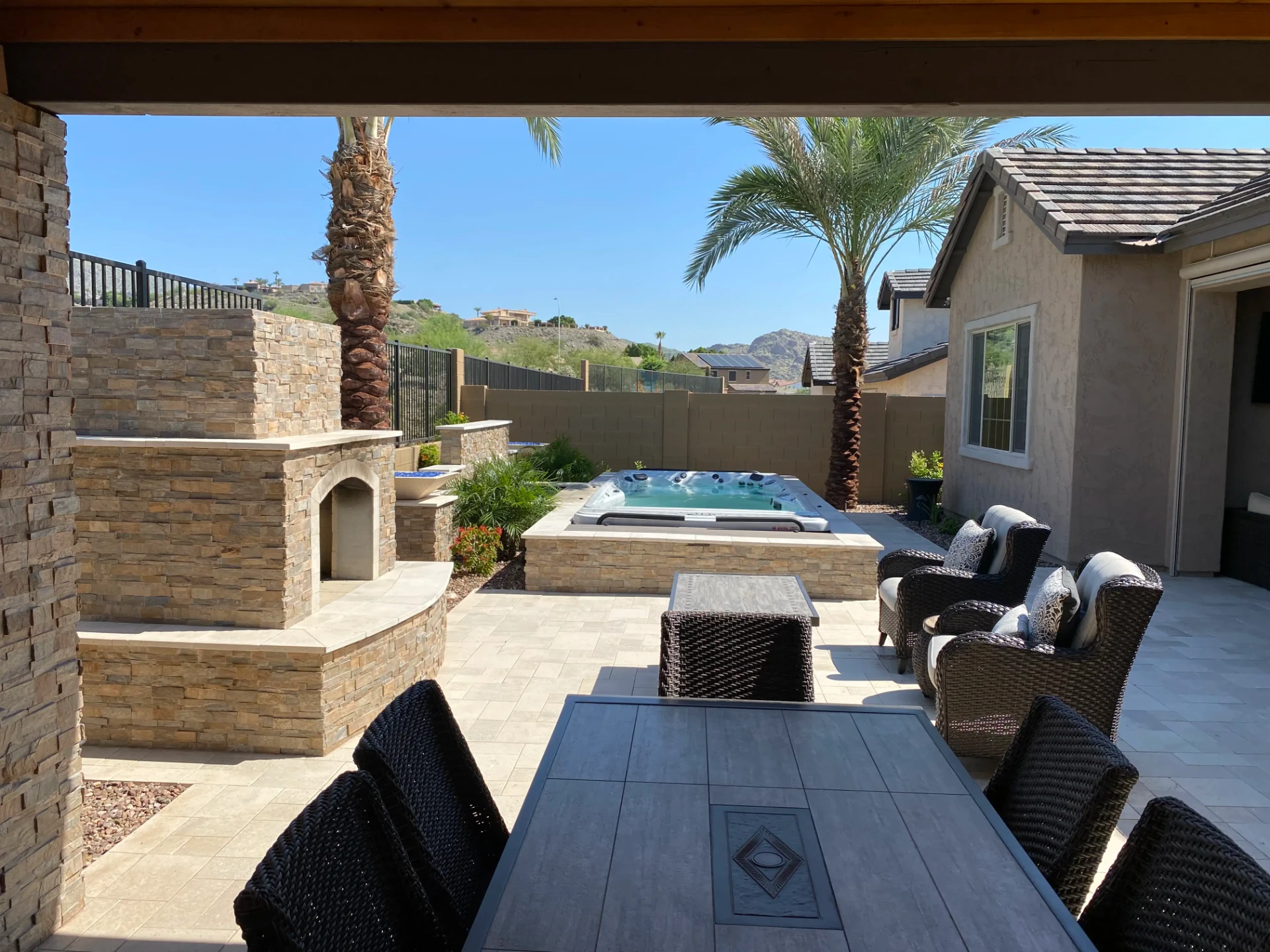 Luxury Arizona backyard with spa, palm trees, and covered patio
